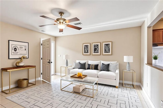 340709 Frenchmen St, New Orleans, LA 70122 - living room with a ceiling fan, light tile patterned floors, and baseboards