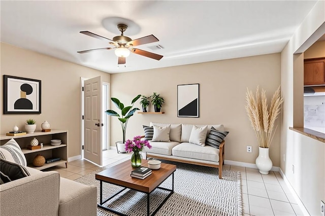 340709 Frenchmen St, New Orleans, LA 70122 - living area featuring light tile patterned floors, a ceiling fan, and baseboards