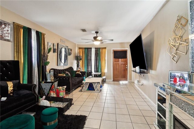 340709 Frenchmen St, New Orleans, LA 70122 - living area with light tile patterned floors, ceiling fan, and baseboards