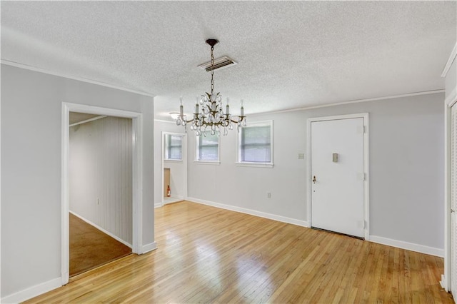 105 Norland Ave, New Orleans, LA 70131 - unfurnished dining area with a chandelier, light wood-style floors, a textured ceiling, and ornamental molding