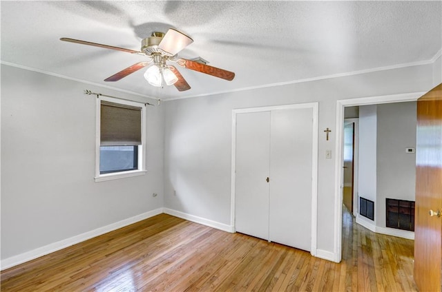 105 Norland Ave, New Orleans, LA 70131 - unfurnished bedroom with wood finished floors, crown molding, a closet, a textured ceiling, and ceiling fan