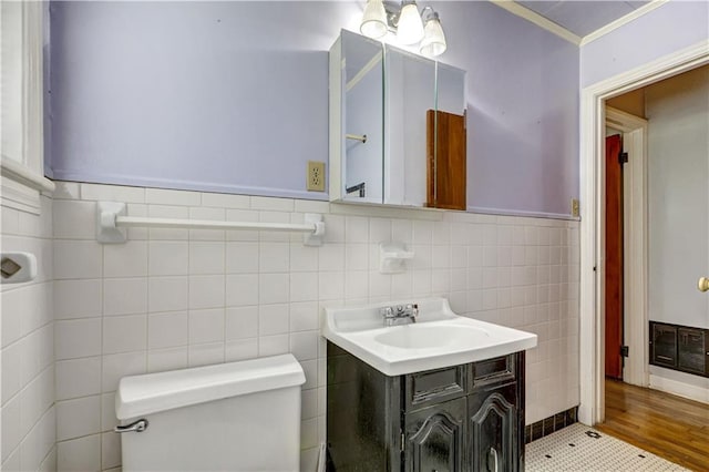 105 Norland Ave, New Orleans, LA 70131 - bathroom with tile walls, vanity, a wainscoted wall, and crown molding
