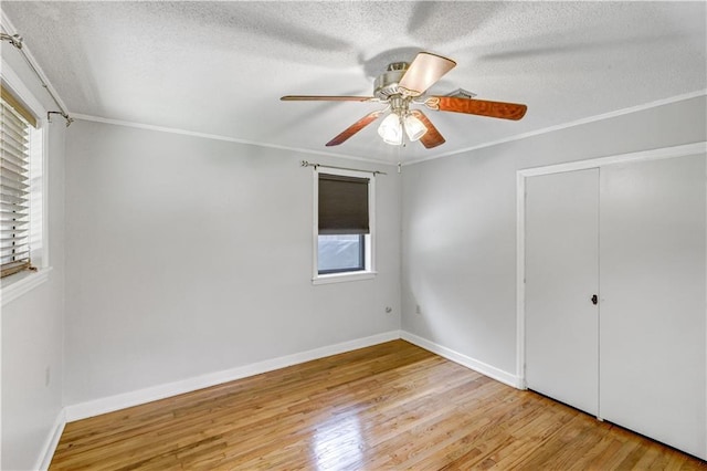 105 Norland Ave, New Orleans, LA 70131 - unfurnished bedroom with wood finished floors, a textured ceiling, crown molding, a ceiling fan, and a closet