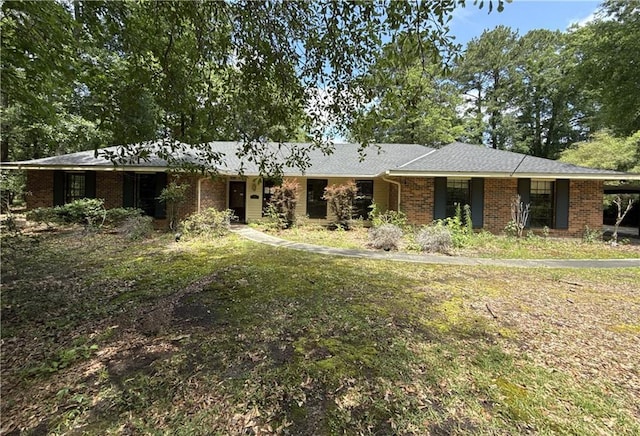 119 Devereux Dr, Slidell, LA 70461 - single story home with brick siding, a carport, and a front lawn