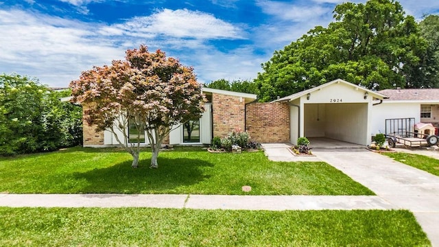 2924 Elizabeth St, Metairie, LA 70003 - view of front of home featuring driveway, a front yard, and a carport