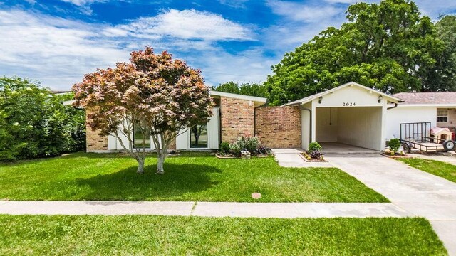 2924 Elizabeth St, Metairie, LA 70003 - view of front of home with driveway, a front yard, and a carport