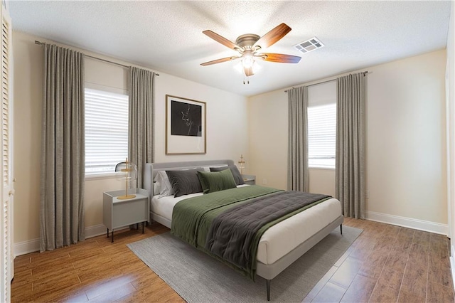 2924 Elizabeth St, Metairie, LA 70003 - bedroom with multiple windows, light wood-type flooring, and baseboards