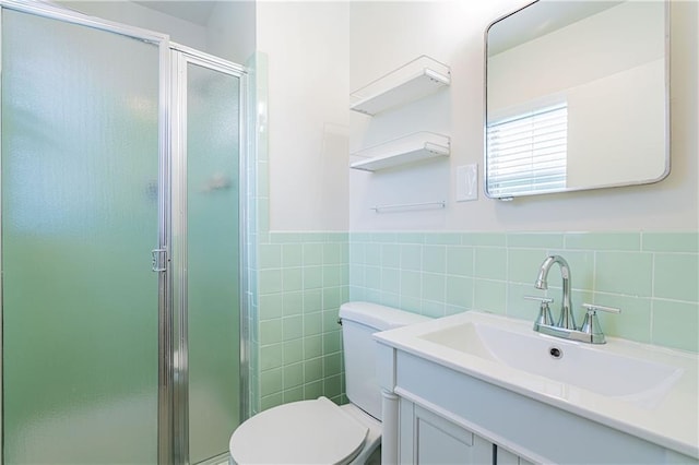 2924 Elizabeth St, Metairie, LA 70003 - bathroom featuring vanity, a stall shower, tile walls, and a wainscoted wall