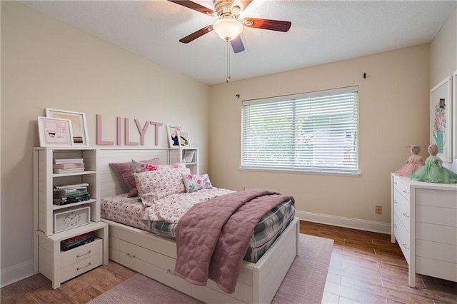 2924 Elizabeth St, Metairie, LA 70003 - bedroom featuring baseboards, light wood finished floors, and a ceiling fan