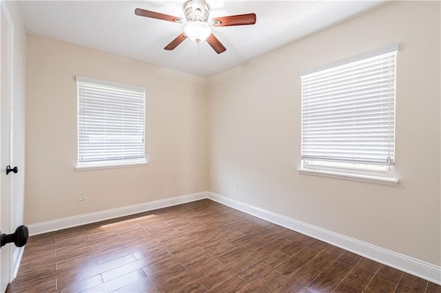 2924 Elizabeth St, Metairie, LA 70003 - spare room with baseboards, dark wood-style flooring, and a ceiling fan