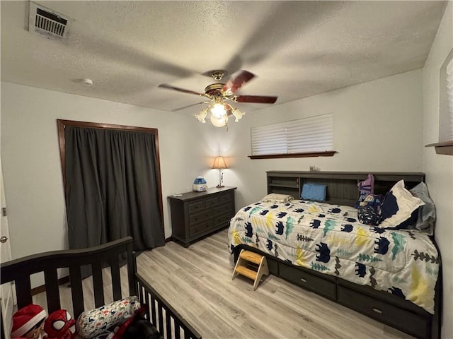 5121 Pike Dr, Metairie, LA 70003 - bedroom featuring wood finished floors, a textured ceiling, and ceiling fan