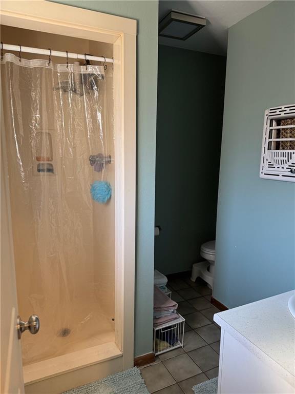 5121 Pike Dr, Metairie, LA 70003 - full bath with tile patterned floors, vanity, and a stall shower