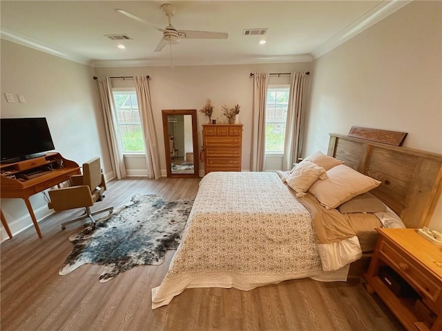 206 E Pecan St, Ponchatoula, LA 70454 - bedroom featuring wood finished floors, multiple windows, ornamental molding, baseboards, and ceiling fan