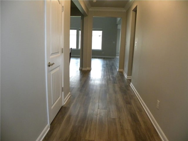 40107 Reese Ln, Prairieville, LA 70769 - hall with ornamental molding, dark wood-style floors, baseboards, and decorative columns