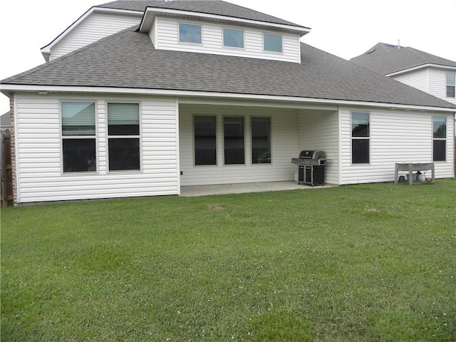 40107 Reese Ln, Prairieville, LA 70769 - rear view of house featuring a shingled roof, a lawn, and a patio