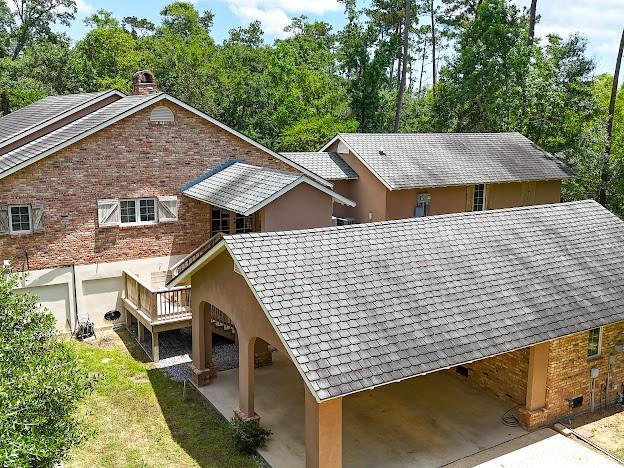 109 Kendrick Dr, Slidell, LA 70461 - view of side of home with a chimney, brick siding, and stucco siding