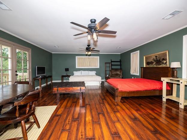 109 Kendrick Dr, Slidell, LA 70461 - bedroom with wood finished floors, crown molding, and baseboards