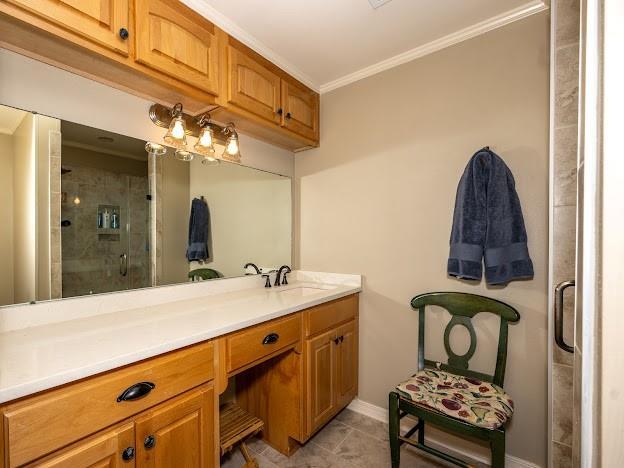 109 Kendrick Dr, Slidell, LA 70461 - full bath with ornamental molding, vanity, a stall shower, tile patterned flooring, and baseboards