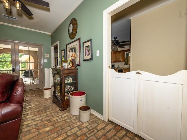 109 Kendrick Dr, Slidell, LA 70461 - living room with ceiling fan, brick floors, crown molding, french doors, and baseboards