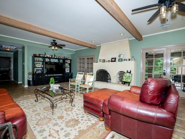 109 Kendrick Dr, Slidell, LA 70461 - living area with ceiling fan, french doors, beamed ceiling, and ornamental molding