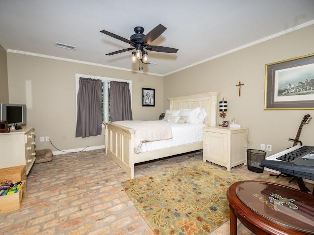 109 Kendrick Dr, Slidell, LA 70461 - bedroom with ornamental molding, brick floors, ceiling fan, and baseboards