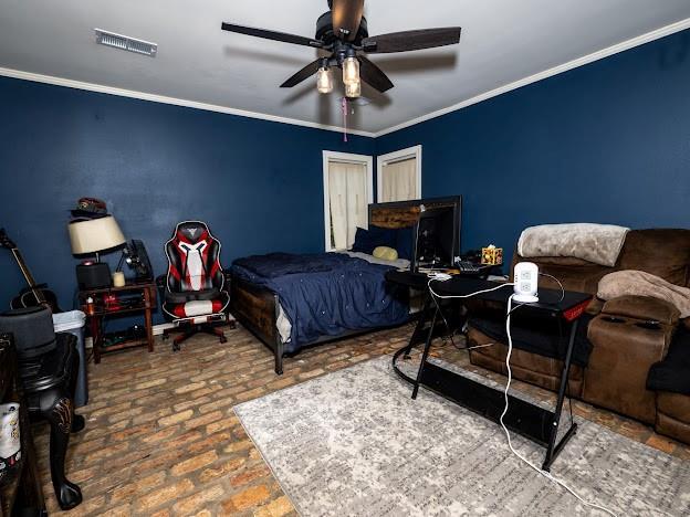 109 Kendrick Dr, Slidell, LA 70461 - bedroom with brick floors, crown molding, and a ceiling fan