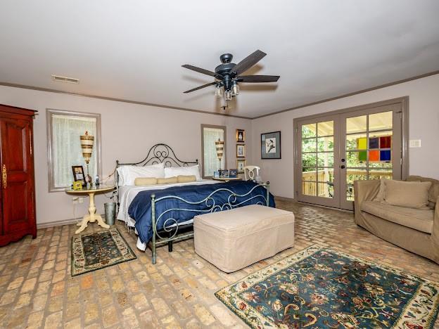 109 Kendrick Dr, Slidell, LA 70461 - bedroom with french doors, access to outside, brick floors, crown molding, and a ceiling fan