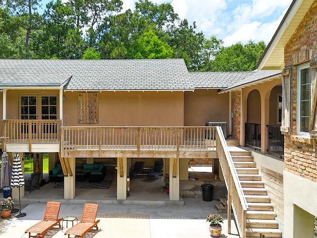 109 Kendrick Dr, Slidell, LA 70461 - back of house with stairway, a patio area, a shingled roof, and stucco siding