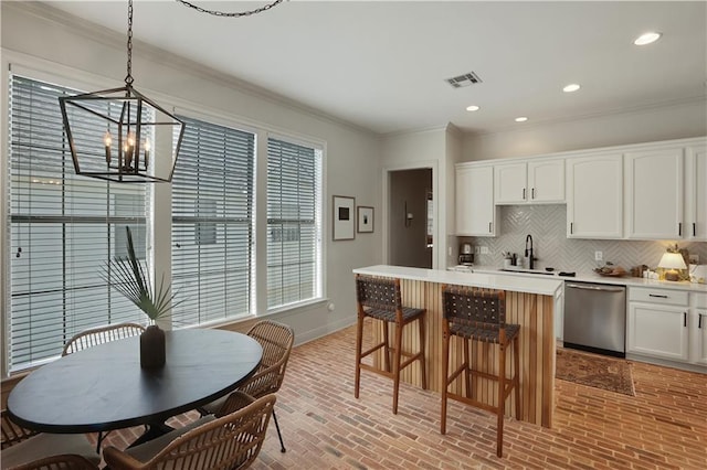 18123 Cusachs Dr, Covington, LA 70433 - kitchen with dishwasher, a sink, brick patterned floors, baseboards, and ornamental molding