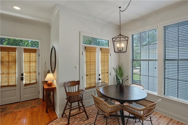 18123 Cusachs Dr, Covington, LA 70433 - dining room featuring plenty of natural light, a chandelier, baseboards, ornamental molding, and french doors