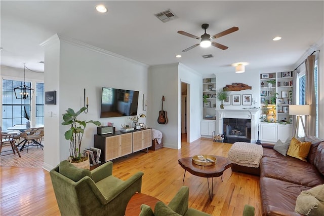 18123 Cusachs Dr, Covington, LA 70433 - living room featuring ceiling fan, healthy amount of natural light, light wood-style flooring, crown molding, and recessed lighting