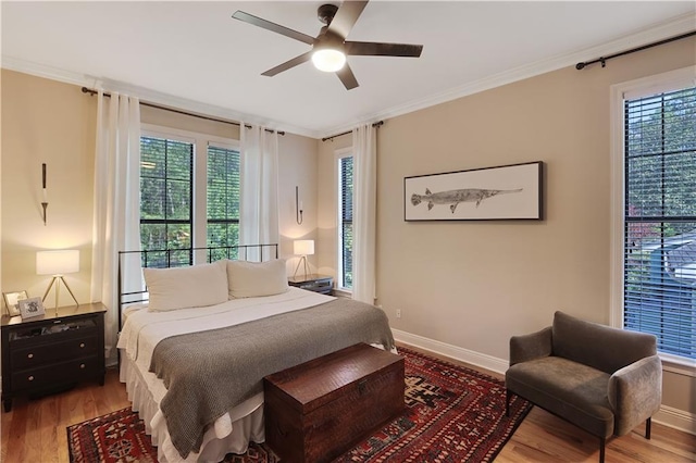 18123 Cusachs Dr, Covington, LA 70433 - bedroom with wood finished floors, multiple windows, crown molding, and baseboards