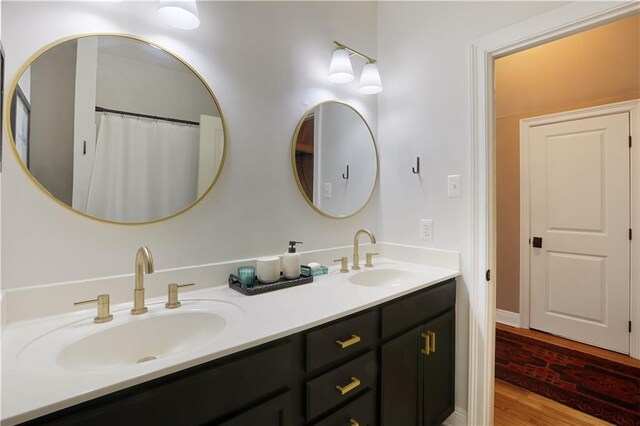 18123 Cusachs Dr, Covington, LA 70433 - bathroom featuring double vanity and wood finished floors