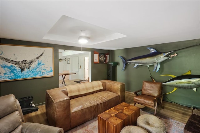 18123 Cusachs Dr, Covington, LA 70433 - home theater room featuring wood finished floors, a raised ceiling, and baseboards