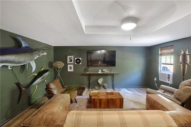 18123 Cusachs Dr, Covington, LA 70433 - living area with wood finished floors, a tray ceiling, and baseboards