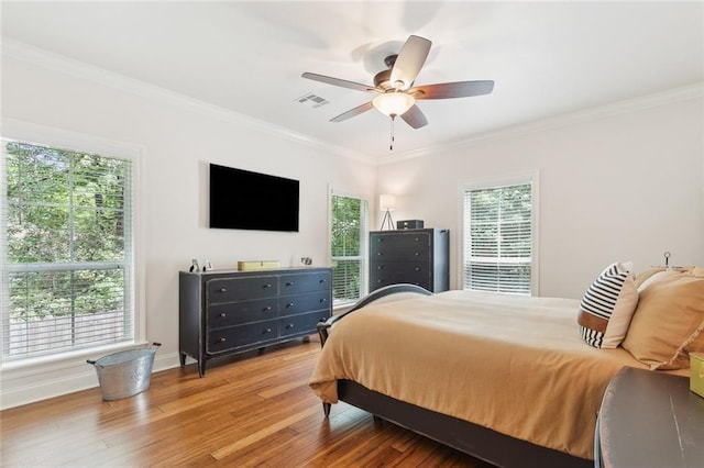 502 W 7th Ave, Covington, LA 70433 - bedroom with crown molding, wood finished floors, ceiling fan, and baseboards