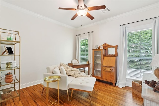 502 W 7th Ave, Covington, LA 70433 - sitting room with light wood-style floors, a ceiling fan, ornamental molding, and baseboards