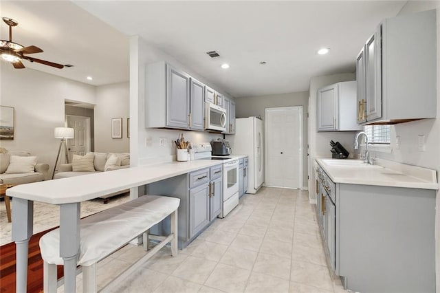 37522 Lopez St, Slidell, LA 70458 - kitchen featuring white appliances, a sink, gray cabinetry, open floor plan, and recessed lighting