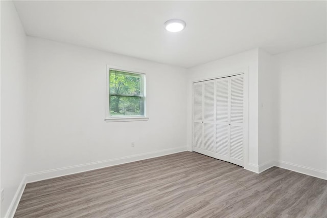 351 Huntington Dr, Slidell, LA 70458 - unfurnished bedroom featuring wood finished floors, a closet, and baseboards