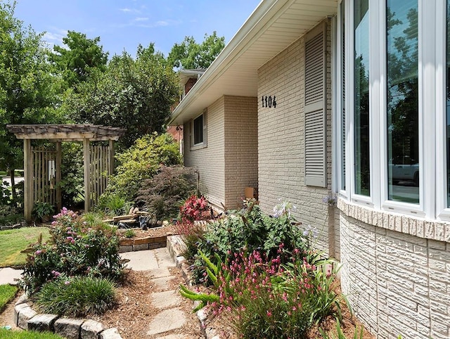 1104 Sena Dr, Metairie, LA 70005 - view of side of home with brick siding and a pergola