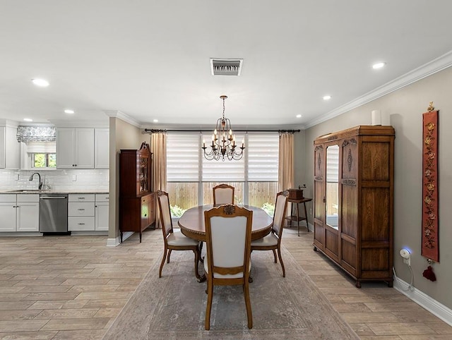 1104 Sena Dr, Metairie, LA 70005 - dining room featuring a chandelier, ornamental molding, light wood finished floors, baseboards, and recessed lighting