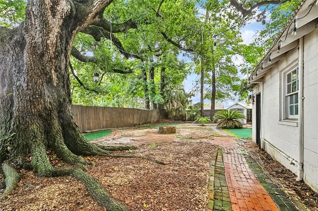 727 Bonnabel Blvd, Metairie, LA 70005 - fenced backyard featuring an outdoor fire pit