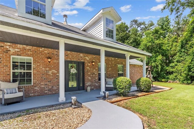 23375 Lowe Davis Rd, Covington, LA 70435 - entrance to property with brick siding, a porch, and a yard