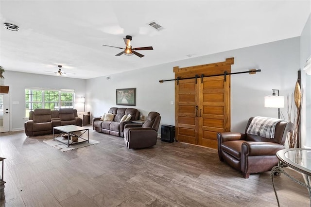 23375 Lowe Davis Rd, Covington, LA 70435 - living room featuring ceiling fan, a barn door, and wood finished floors