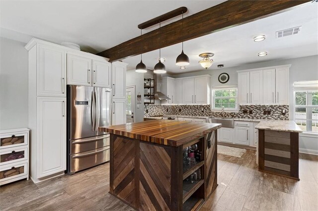 23375 Lowe Davis Rd, Covington, LA 70435 - kitchen with stainless steel refrigerator, wooden counters, a sink, plenty of natural light, and beam ceiling