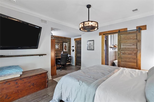 23375 Lowe Davis Rd, Covington, LA 70435 - bedroom with wood finished floors, a barn door, crown molding, baseboards, and an office area