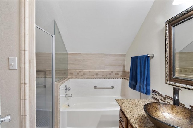 23375 Lowe Davis Rd, Covington, LA 70435 - bathroom with lofted ceiling, a garden tub, vanity, and a stall shower