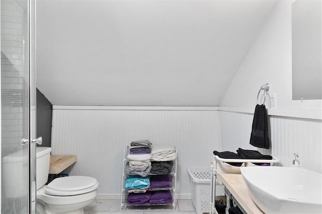 23375 Lowe Davis Rd, Covington, LA 70435 - full bath featuring toilet, vanity, a shower stall, a wainscoted wall, and vaulted ceiling