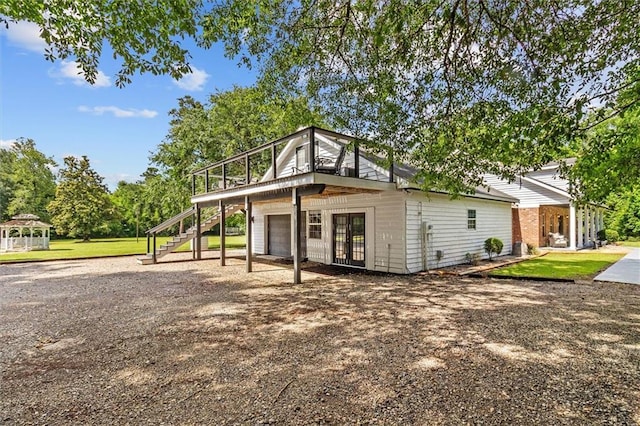 23375 Lowe Davis Rd, Covington, LA 70435 - view of community with a garage, stairway, a wooden deck, driveway, and a lawn