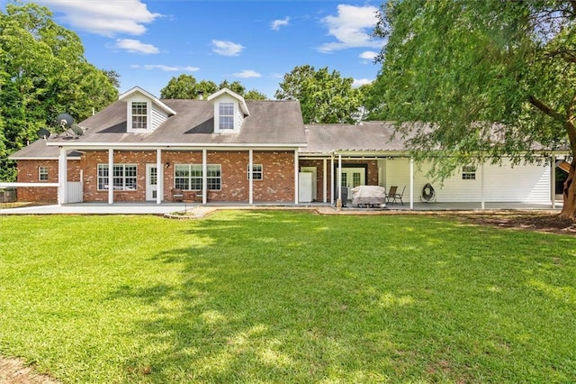 23375 Lowe Davis Rd, Covington, LA 70435 - rear view of house with a patio, brick siding, and a lawn